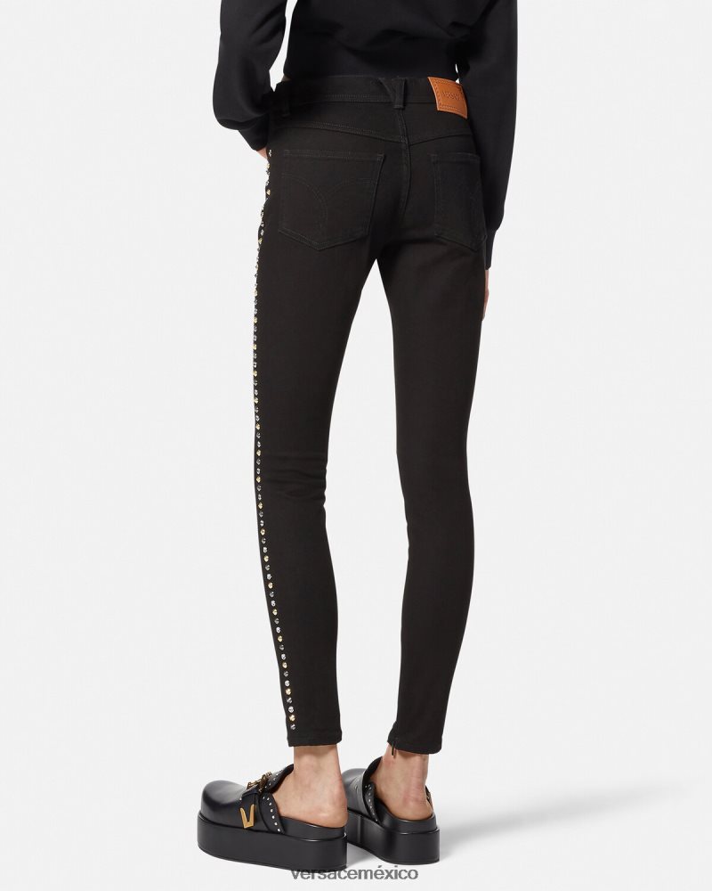 Versace jeans ajustados con tachuelas de Medusa negro ropa mujer 84626J214