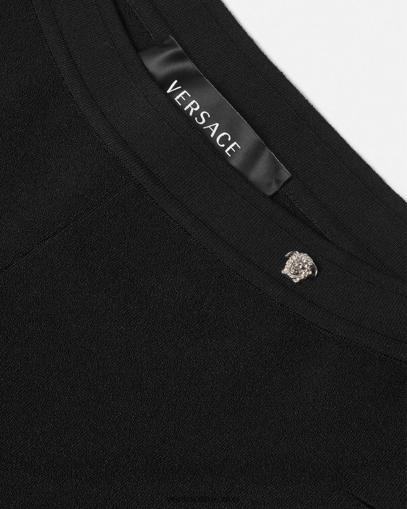 Versace pantalones acampanados de punto con cortes negro ropa mujer 84626J208
